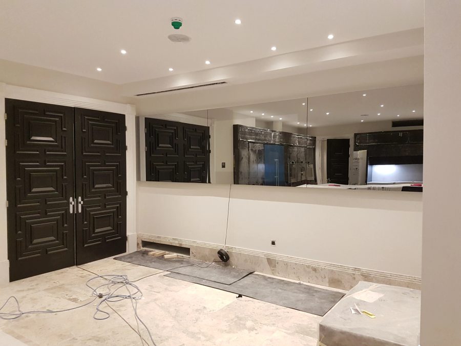 Full-Width Kitchen Mirror TV Wall — screen off